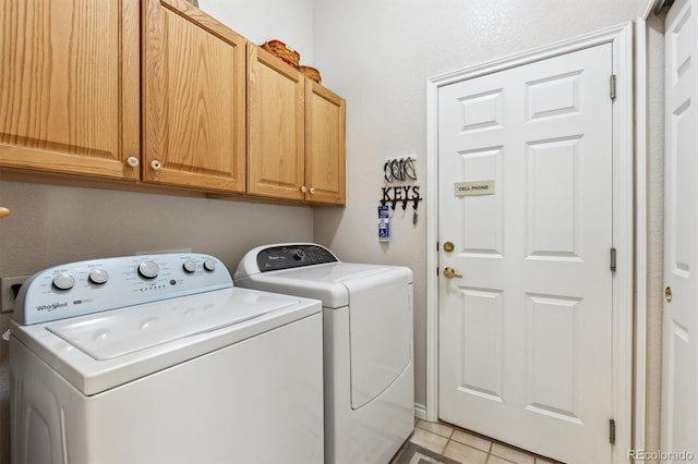 3145 Stevens Cir, Erie, CO 80516 - washroom featuring cabinet space, washing machine and clothes dryer, and light tile patterned flooring