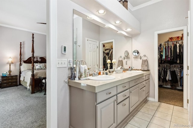 3145 Stevens Cir, Erie, CO 80516 - ensuite bathroom featuring ornamental molding, double vanity, a spacious closet, tile patterned floors, and recessed lighting