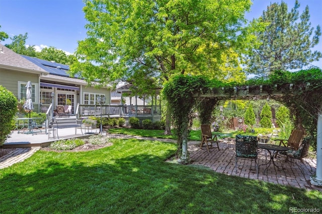 3145 Stevens Cir, Erie, CO 80516 - view of green lawn with a patio and a wooden deck