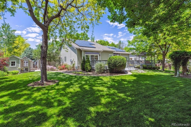 3145 Stevens Cir, Erie, CO 80516 - rear view of house featuring roof mounted solar panels and a yard