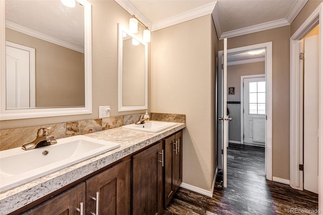 bathroom featuring crown molding, vanity, and hardwood / wood-style flooring