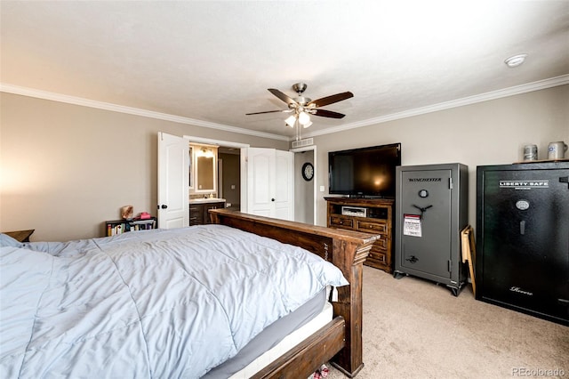 bedroom featuring crown molding, light carpet, ceiling fan, and ensuite bath