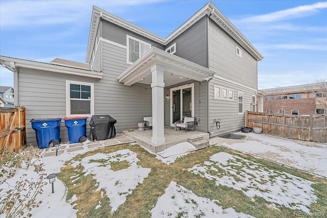 snow covered property featuring a patio area