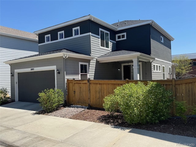 10092 Flower St, Broomfield, CO 80021 - view of front facade featuring fence, concrete driveway, and a garage