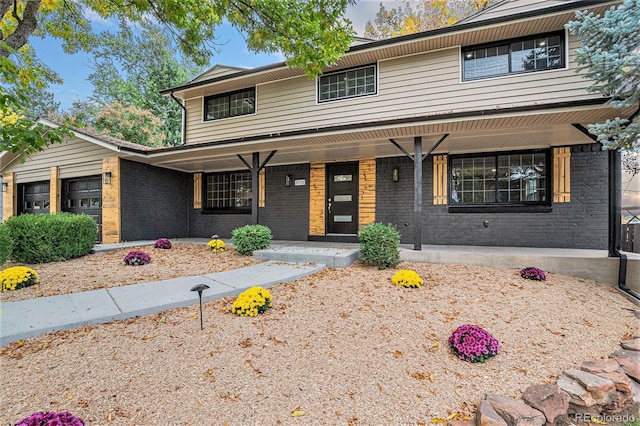 front of property with covered porch and a garage