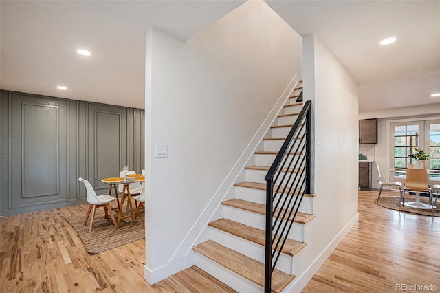 stairs with hardwood / wood-style floors