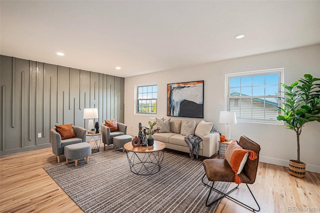 living room with light wood-type flooring and plenty of natural light