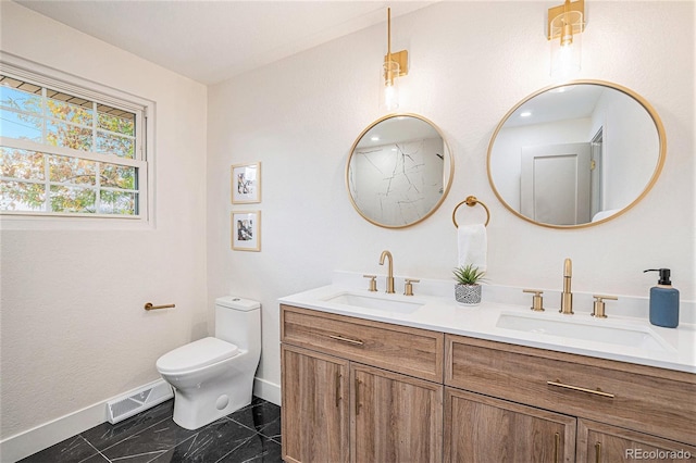 bathroom featuring vanity and toilet