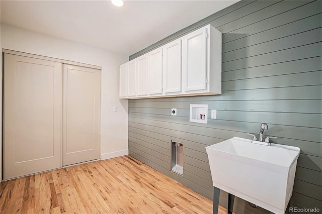 washroom featuring wood walls, washer hookup, hookup for an electric dryer, and light wood-type flooring