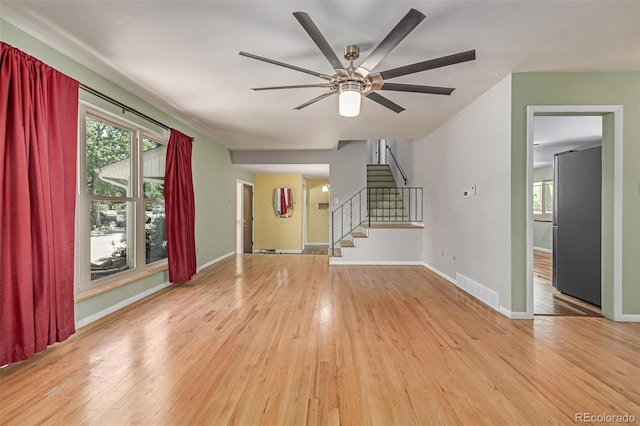 305 Titan St, Aurora, CO 80011 - unfurnished room with plenty of natural light, ceiling fan, light wood-style floors, and baseboards