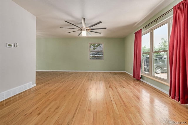 305 Titan St, Aurora, CO 80011 - unfurnished room with wood finished floors, ceiling fan, and baseboards