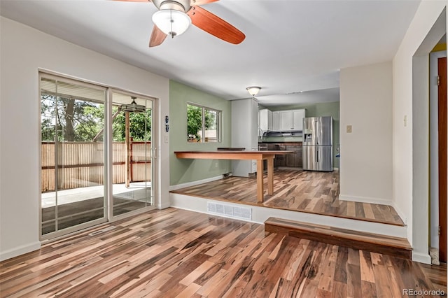 305 Titan St, Aurora, CO 80011 - unfurnished living room featuring wood finished floors, baseboards, and a ceiling fan