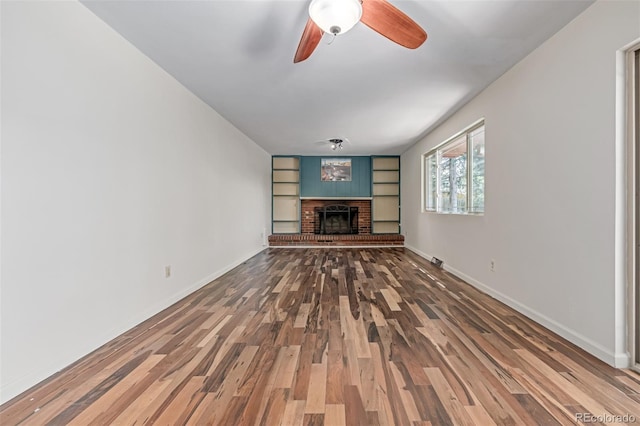 305 Titan St, Aurora, CO 80011 - unfurnished living room featuring wood finished floors, ceiling fan, baseboards, and a fireplace