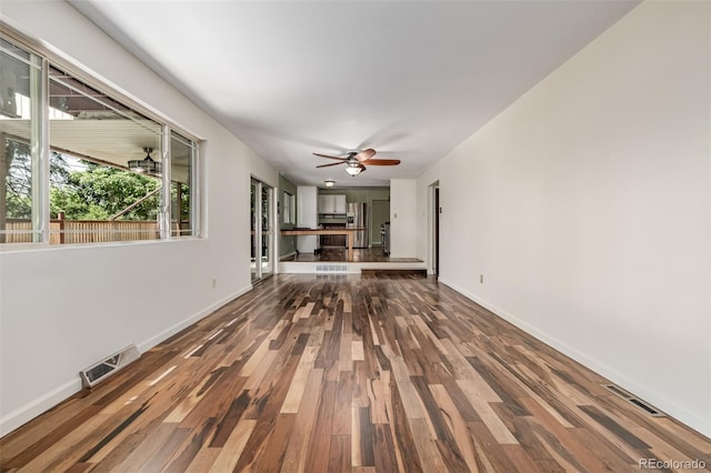 305 Titan St, Aurora, CO 80011 - unfurnished living room with wood finished floors, ceiling fan, and baseboards