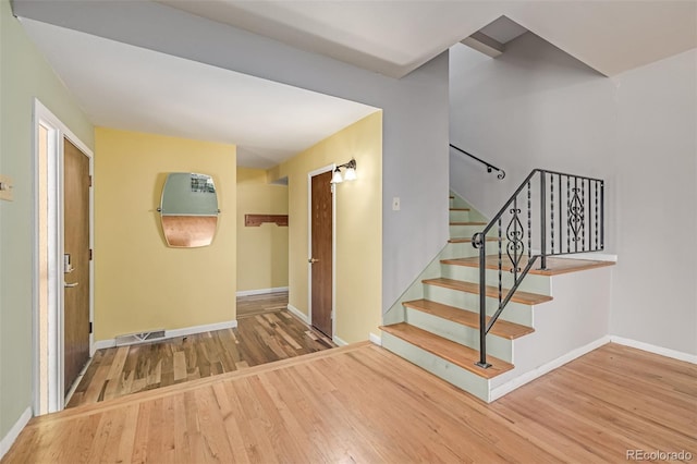 305 Titan St, Aurora, CO 80011 - staircase featuring wood finished floors and baseboards