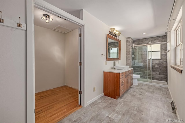 305 Titan St, Aurora, CO 80011 - full bath with vanity, toilet, wood finished floors, and a stall shower