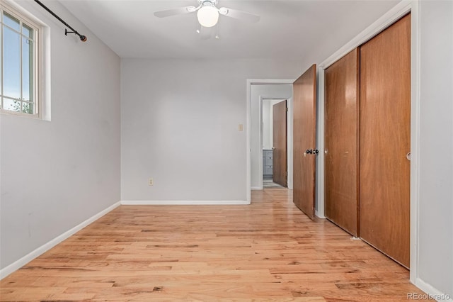 305 Titan St, Aurora, CO 80011 - unfurnished bedroom with light wood finished floors, a closet, baseboards, and ceiling fan