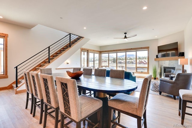 148 Hay Meadow Dr, Fraser, CO 80442 - dining space with stairway, a tile fireplace, recessed lighting, ceiling fan, and light wood finished floors