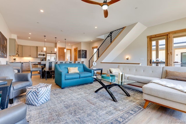 148 Hay Meadow Dr, Fraser, CO 80442 - living room featuring light wood-type flooring, stairway, a ceiling fan, and recessed lighting