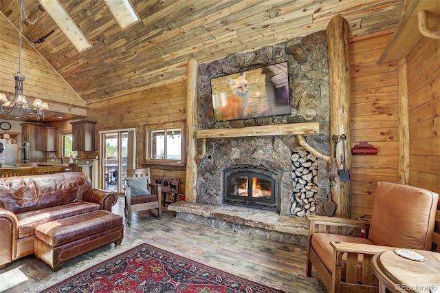 living room with hardwood / wood-style floors, a stone fireplace, wooden ceiling, high vaulted ceiling, and wooden walls