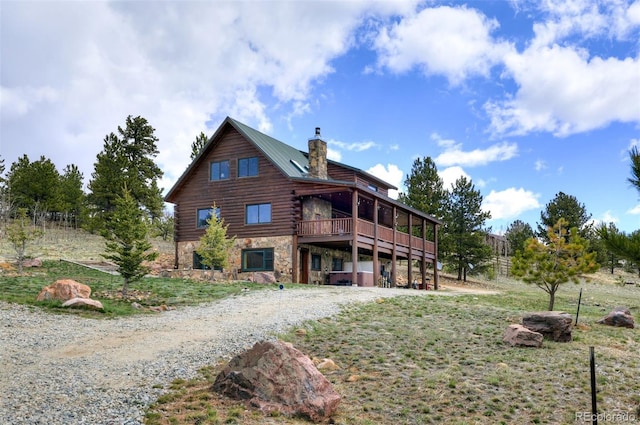 back of property featuring a wooden deck