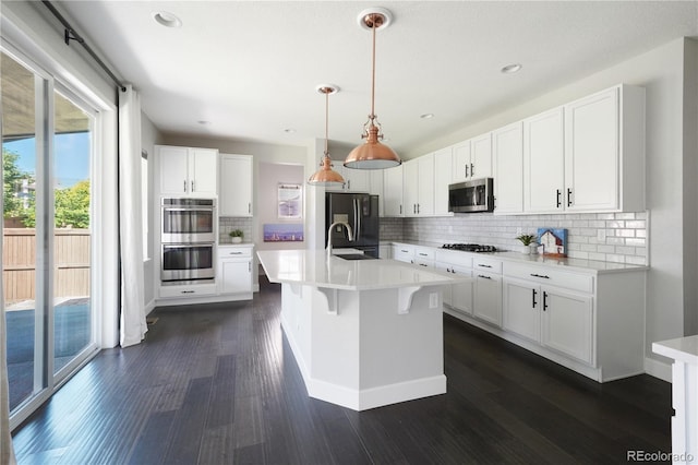 15378 W 50th Pl, Golden, CO 80403 - kitchen featuring appliances with stainless steel finishes, light countertops, dark wood-style flooring, decorative backsplash, and recessed lighting