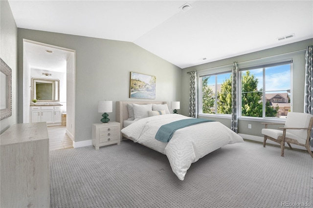 15378 W 50th Pl, Golden, CO 80403 - bedroom featuring vaulted ceiling, connected bathroom, and light carpet