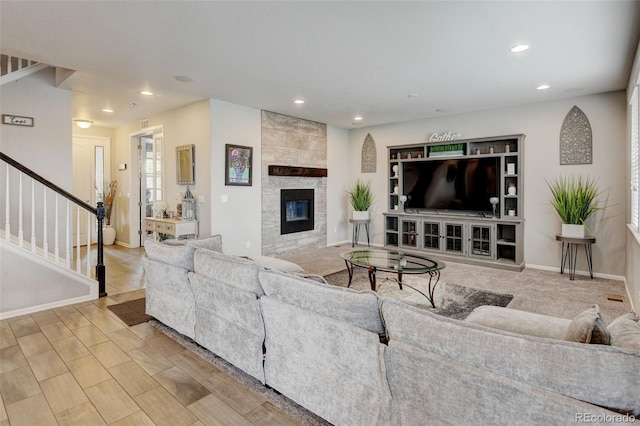 8071 Tabor St, Arvada, CO 80005 - living room featuring stairs, recessed lighting, and a tiled fireplace