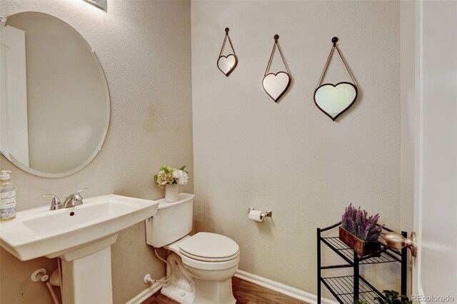 8071 Tabor St, Arvada, CO 80005 - bathroom with toilet and wood finished floors