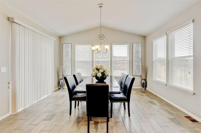 8071 Tabor St, Arvada, CO 80005 - dining space with a chandelier, light wood-type flooring, and vaulted ceiling