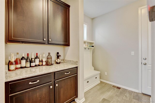 8071 Tabor St, Arvada, CO 80005 - bar area with baseboards and light wood-style flooring