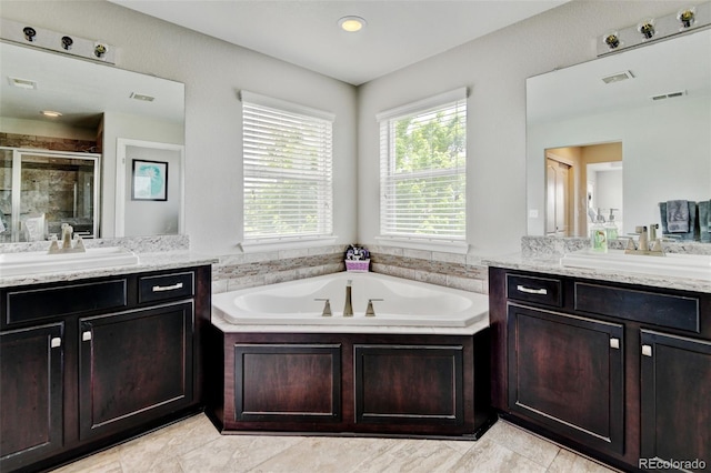 8071 Tabor St, Arvada, CO 80005 - full bath with a stall shower, two vanities, a bath, and tile patterned floors