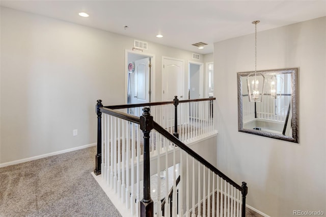 8071 Tabor St, Arvada, CO 80005 - hallway featuring an upstairs landing, carpet, a chandelier, and recessed lighting