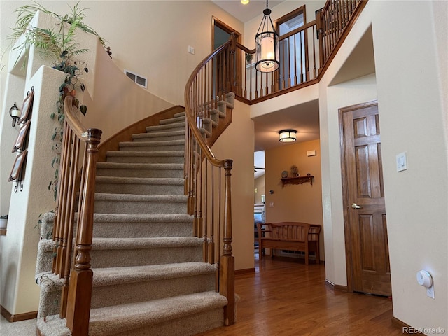 2369 Bayberry Ln, Castle Rock, CO 80104 - stairway with wood finished floors, a high ceiling, and baseboards