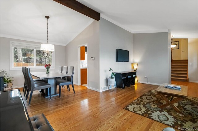 1768 E Jamison Ave, Centennial, CO 80122 - dining area with stairs, a chandelier, wood finished floors, and baseboards