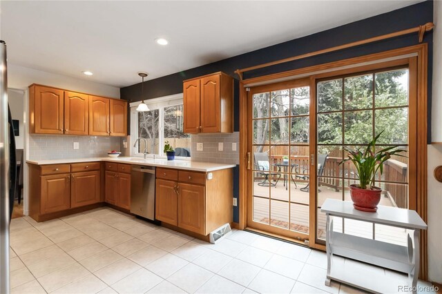 1768 E Jamison Ave, Centennial, CO 80122 - kitchen with stainless steel dishwasher, light countertops, tasteful backsplash, recessed lighting, and brown cabinetry