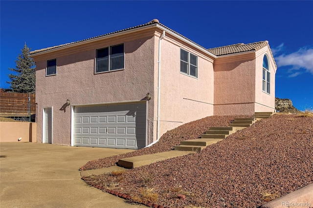 view of side of property with a garage