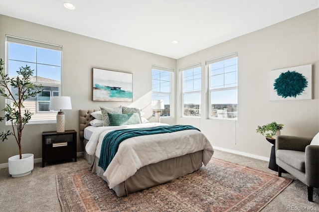 carpeted bedroom with multiple windows