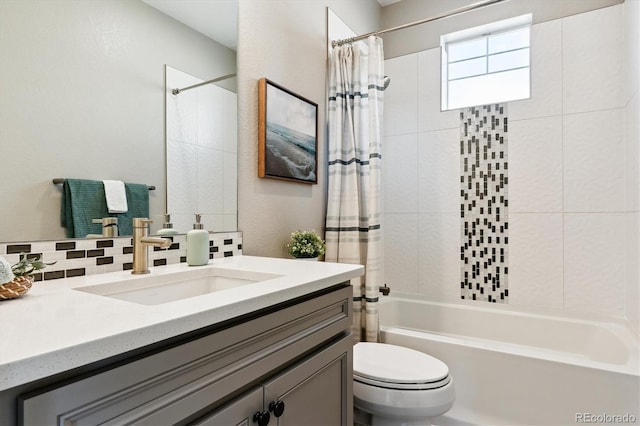 full bathroom featuring vanity, backsplash, toilet, and shower / bath combo with shower curtain