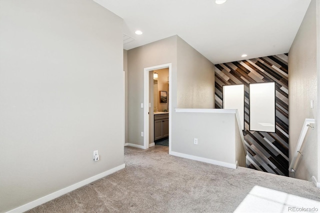 interior space featuring light colored carpet and connected bathroom