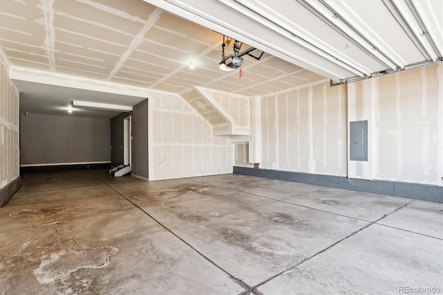 garage with a garage door opener and electric panel