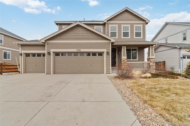 craftsman house with a garage, covered porch, and a front lawn