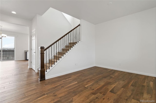 interior space with dark hardwood / wood-style floors and an inviting chandelier