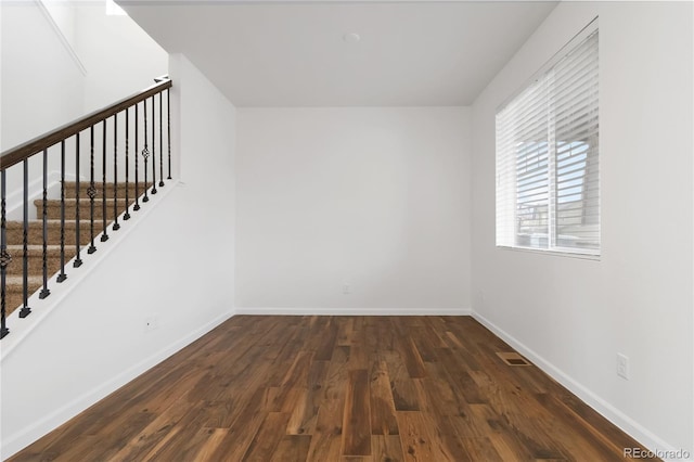 unfurnished room with dark hardwood / wood-style floors