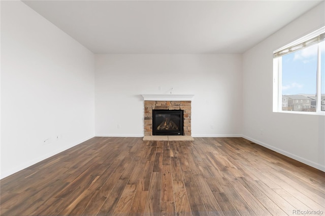 unfurnished living room featuring wood-type flooring and a fireplace