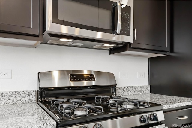 kitchen with light stone counters and stainless steel appliances