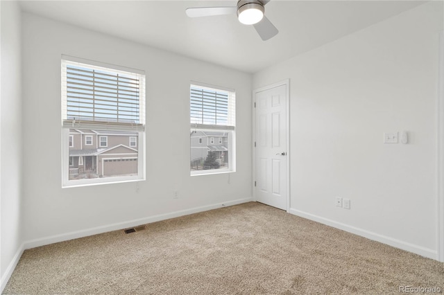 carpeted empty room featuring ceiling fan