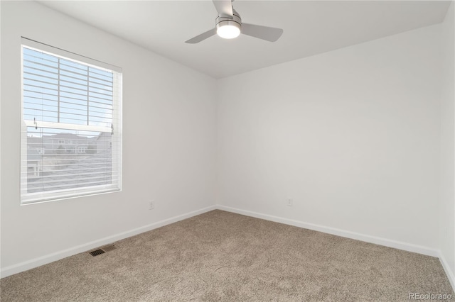 spare room featuring carpet and ceiling fan