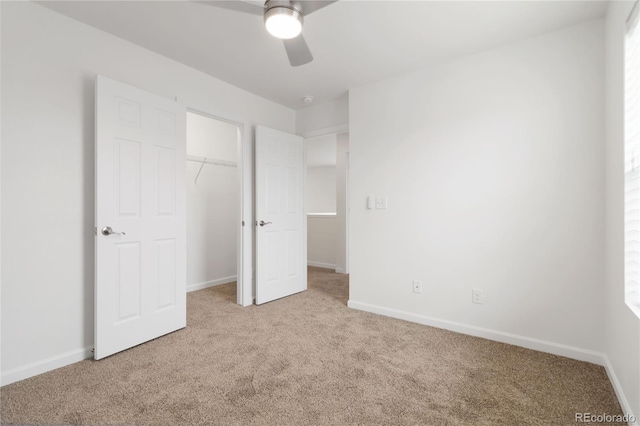 unfurnished bedroom featuring light colored carpet, ceiling fan, and a closet