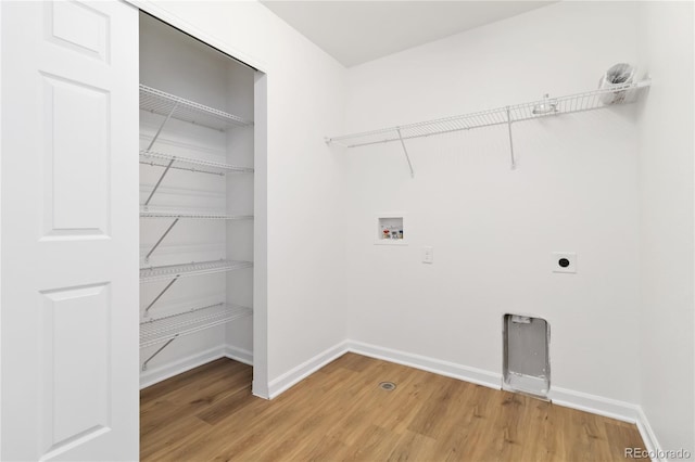 washroom with hardwood / wood-style flooring, hookup for an electric dryer, and washer hookup